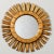 Giltwood mirror in sunburst form has rays with jagged tips and an incised scallop design on the inner frame, circa 1960s....