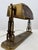 early 20th-century bronze table or desk lamp featuring a stylized rams head motif and an acid-etched glass shade. Strong...