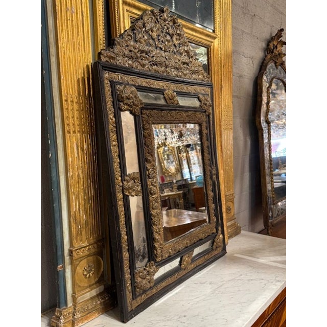 The 19th Century Dutch Brass Repousse Cushion Mirror features a stunning mirrored frame finished in brass. This antique...