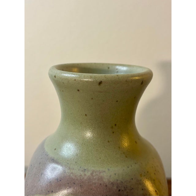 A refined American studio pottery vase from the mid-century period, featuring a soft, nuanced glaze in pale purples and...