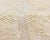 A quietly luxurious ivory rug, its plush surface carrying only the faintest hand-woven diamond pattern — a study in...