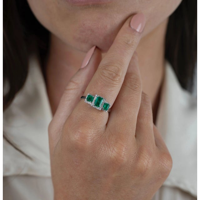 Genuine emerald and diamond 3 stone ring, set in 18 karat solid white gold with a prong and pave mounting. This ring...