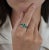 Genuine emerald and diamond 3 stone ring, set in 18 karat solid white gold with a prong and pave mounting. This ring...