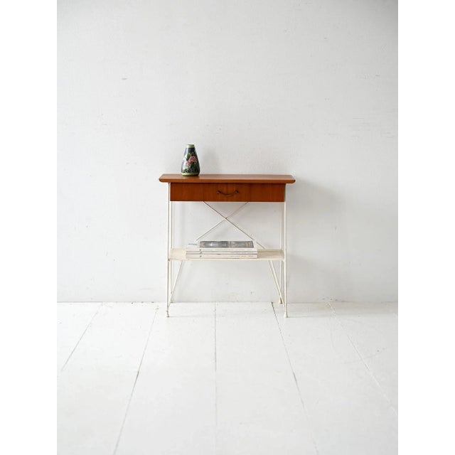 Scandinavian bedside table from the 1960s with a mahogany drawer and lacquered metal frame with a slatted bookshelf....