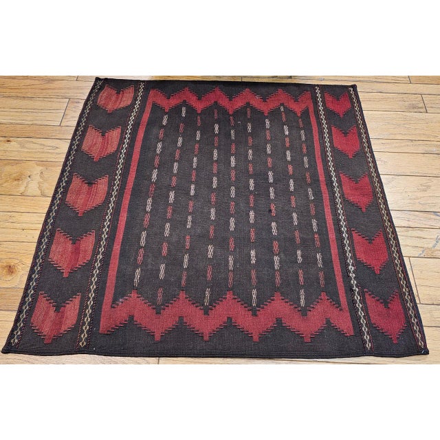 This exceptionally rare early 20th-century Persian Baluch Tribal Sofreh Kilim is a highly collectible piece of authentic...