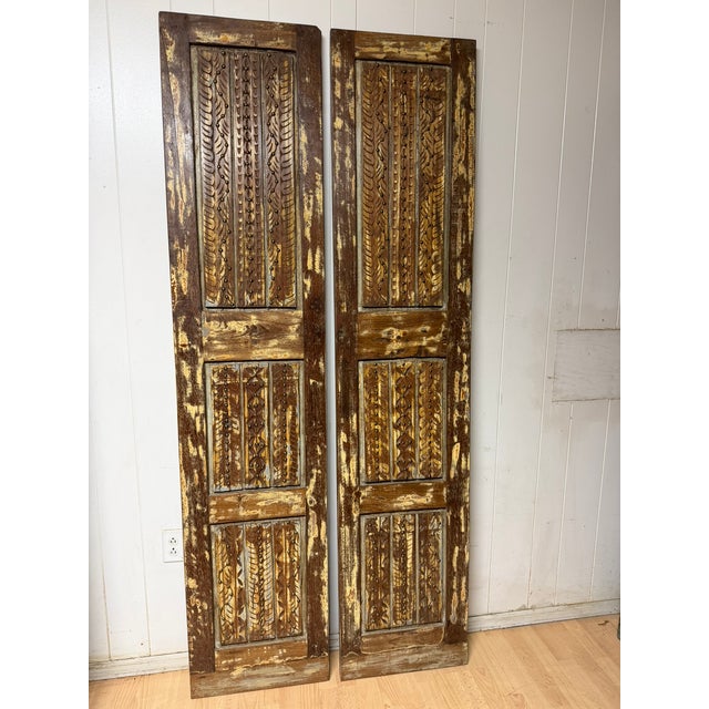 Bring centuries-old craftsmanship into your home with these antique carved wood double doors, beautifully adorned with...