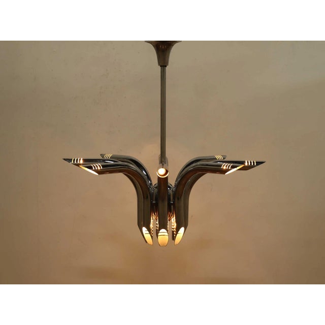 A sculptural tour‑de‑force of polished chrome, this 1980s Italian “pipe” chandelier—widely attributed to lighting...