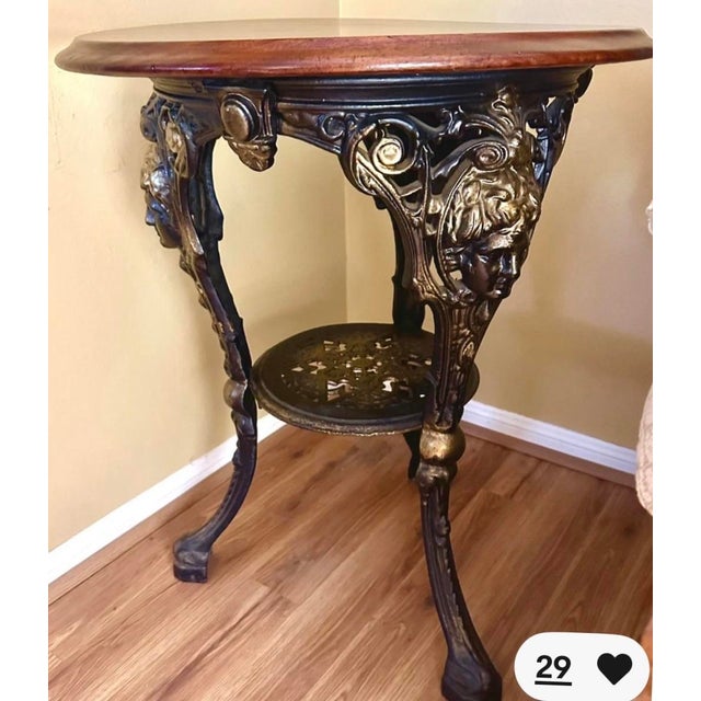 This is a beautiful antique pub table that we bought while living in London. The top is mahogany and secured to the cast...