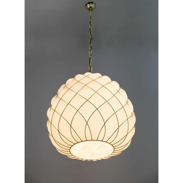 Number four Suspension lamps, produced using the ancient technique of cage-blown glass: the master glassmaker blows into...