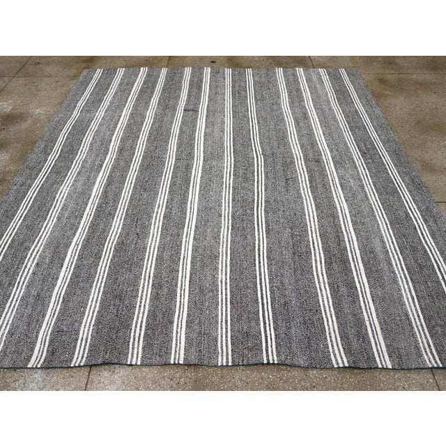 A vintage Turkish flatweave Kilim small square room size carpet handmade during the Mid-20th Century. Measures: 8' 9" x 9'...