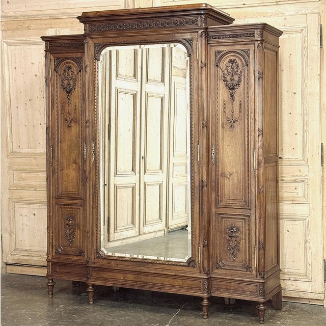 19th Century French Louis XVI Walnut Triple Armoire was crafted from select French walnut and finely cast brass, the...