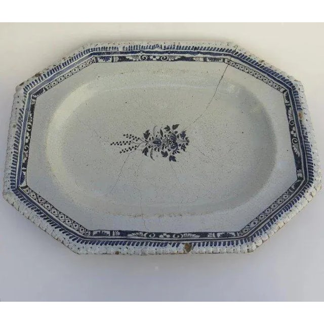 Charming French faience platter. Center sprig of flowers, crimped edge. Old staple repair. 15 1/2" by 11 1/2". Container. A