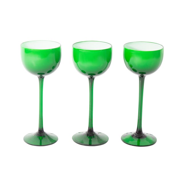 A set of three glasses produced by Carlo Moretti. Made in Italy, this set is made of green and white cased glass. The...