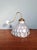 Wall sconce with a mercury glass globe produced by the english manufacturer helioray, and a brass and porcelain gooseneck...