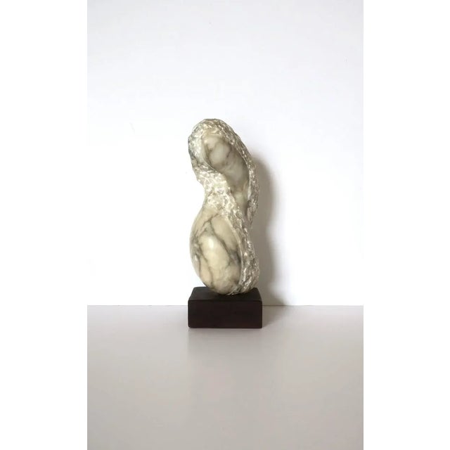 A substantial organic modern alabaster marble sculpture, in the style of artist Joan Shapiro, circa mid-20th century. This...