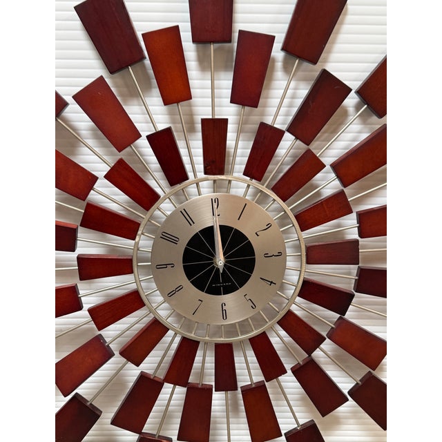 Design Plus Gallery presents a Sunburst Wall Clock from Kenneth Wingard. The clock is of mixed materials with metal rods...