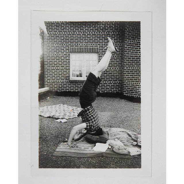 1950's snapshot photograph of young woman doing a handstand. Unframed.