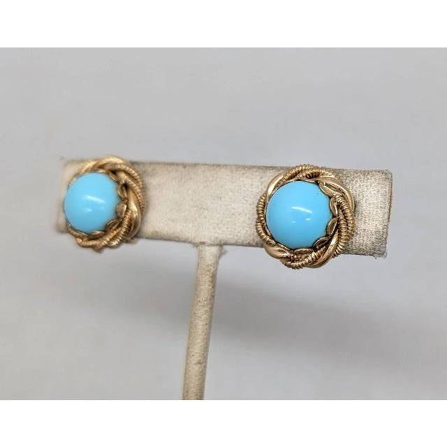 1950s goldtone cabochon faux-tuquoise with "twisted" goldtone surround clip earrings. Marked "NAPIER PAT. PEND." on the...