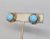 1950s goldtone cabochon faux-tuquoise with "twisted" goldtone surround clip earrings. Marked "NAPIER PAT. PEND." on the...