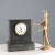 Black marble table clock. Enamelled metal dial with Roman numerals, protected by a glass cover. This piece is attributed...