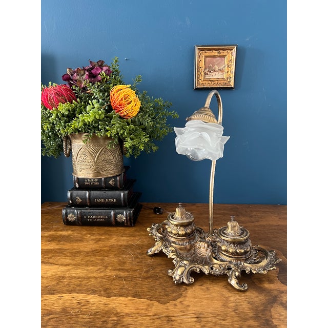 An exquisite antique desk lamp dating to the early 20th century, crafted in an ornate Rococo Revival form with richly...