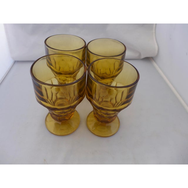 Set of four (4) Mid-Century Modern glasses. These feature a honeycomb amber hue. Great water or wine glasses. 3.25'D X...