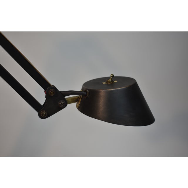 Articulated brass and steel task lamp designed and fabricated by Oblik studio inc. Blackened steel body with brass raceway...