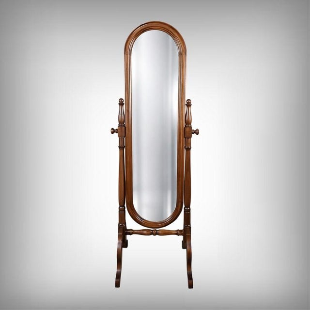 This solid mahogany cheval mirror is distinguished by the deep warmth of its fine wood. Its oval mirror, delicately set in...