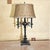 This vintage Victorian‑style candelabra table lamp features an ornate cast‑metal body with scrolling arms, decorative...