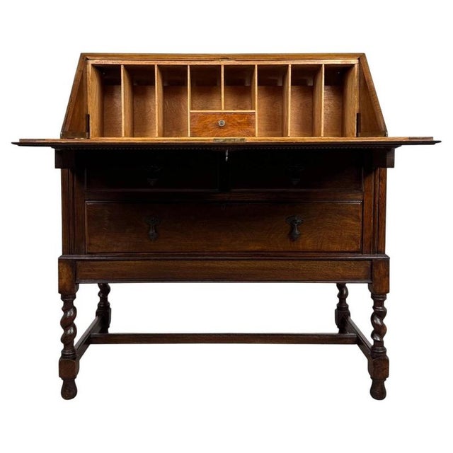 A handsome early 20th-century English bureau in the Jacobean style, finely crafted from oak and distinguished by its...