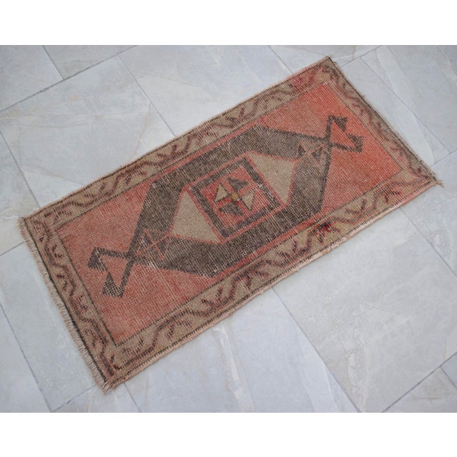 an Vintage small rug. Medium wood background color yastik rug perfect for a small guest bath or in front of the kitchen...