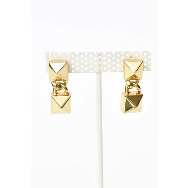 This is part of Chairish’s Costume Jewelry assortment. These dynamic pair of signed Fallon pierced dangle drop earrings...
