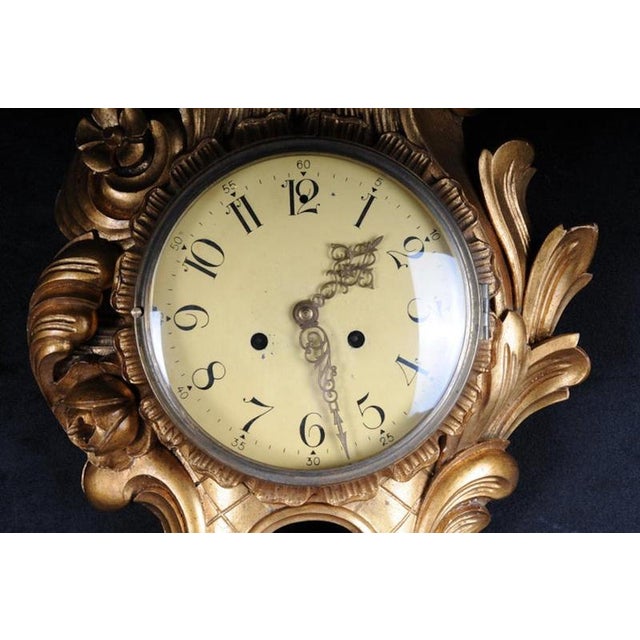 Solid wood hand-carved with rich rococo elements. Roman dial. Glazed. Clockwork should be checked for accuracy.