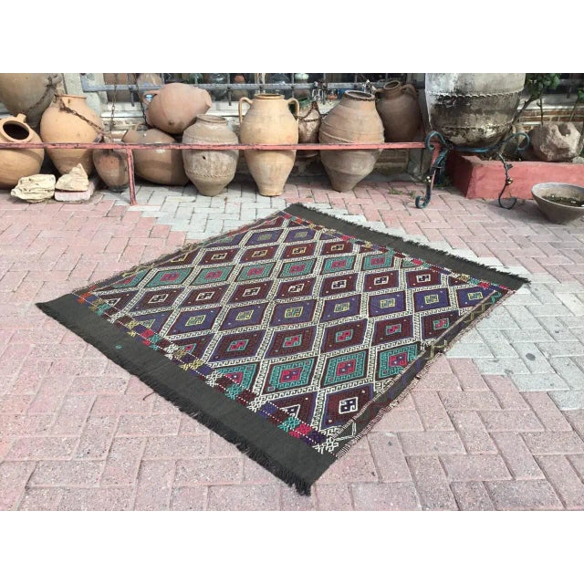 This beautiful, traditional vintage, flatweaved Turkish kilim rug is approximately 60 years old. It is handmade of very...