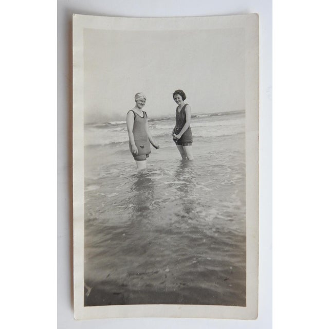 Early 20th century snapshot photograph of two young women in bathing suits at the beach. Unframed.
