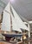 The beauty and grace of a classic gaff rigged sloop is admired even by landlubbers and this vintage wooden model on stand...