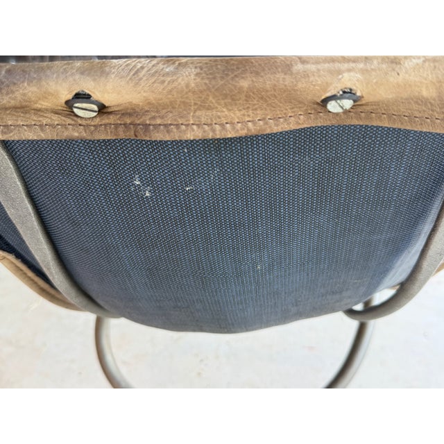Iron and leather dining arm chairs. Scroll detail. Scoop dip style seat. Use as a pair in living room or sitting area or...