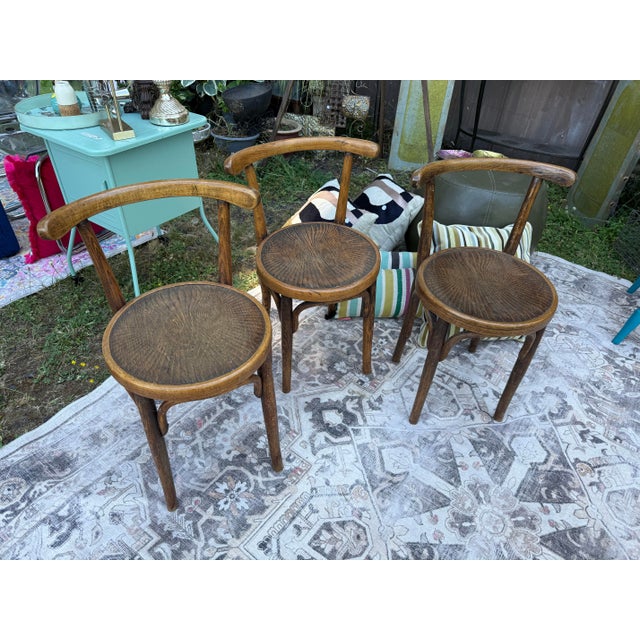 Frame in dark stained bent wood. Seat in plywood with decorative pattern.