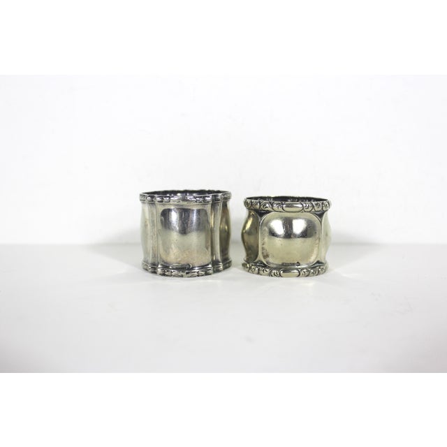 Beautiful pair of mismatched signed and hallmarked Robert Kraft alpaca silver metal napkin rings. Very good vintage...