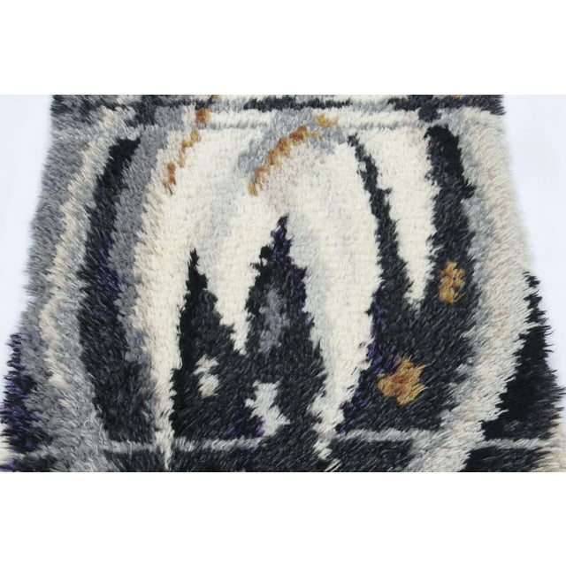 Hand-knotted in lush, high-pile wool in Sweden circa 1960-1970, this 2x4 vintage Swedish Rya rug is a bold new addition to...
