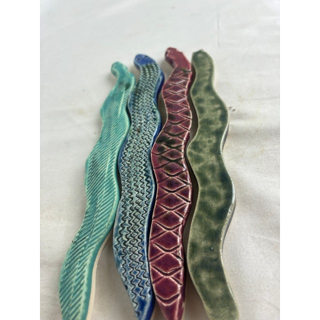 Gorgeous handmade ceramic trivet by artist Linda Hoffhines. The trivet is composed of 4 colorful ceramic snakes in jewel...