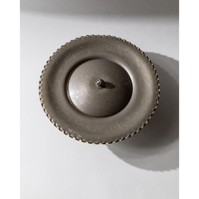 This vintage silver-plated lidded bowl from the 1960s is an elegant and generously sized centerpiece, designed to elevate...