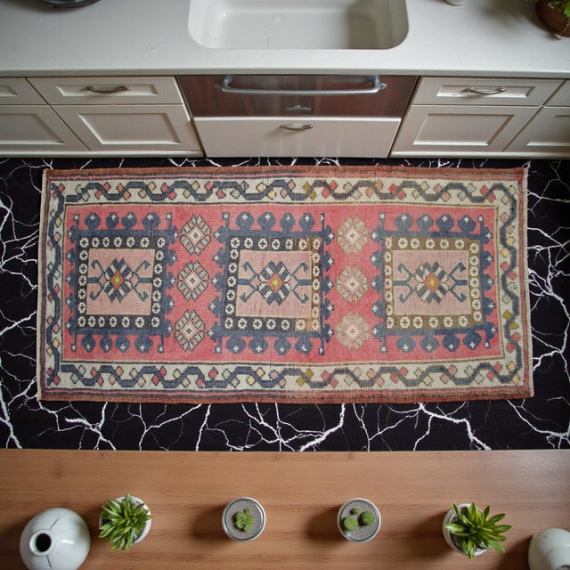 This vintage hand-knotted Oushak rug showcases a delightful blend of pastel tones and geometric precision, perfect for...