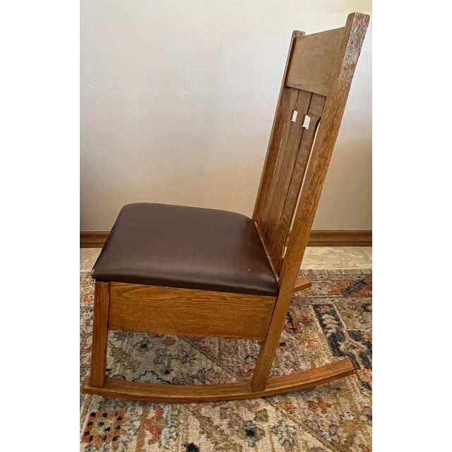This is a great little rocker from the Arts & Crafts period. It has a nice patina on the oak construction which uses both...
