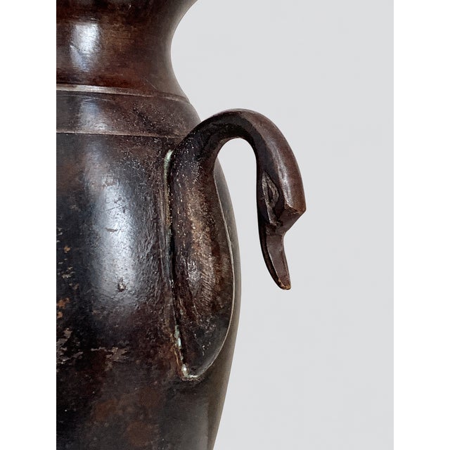 A beautifully restrained early 19th-century French patinated bronze vase in the Neoclassical tradition of the Empire and...