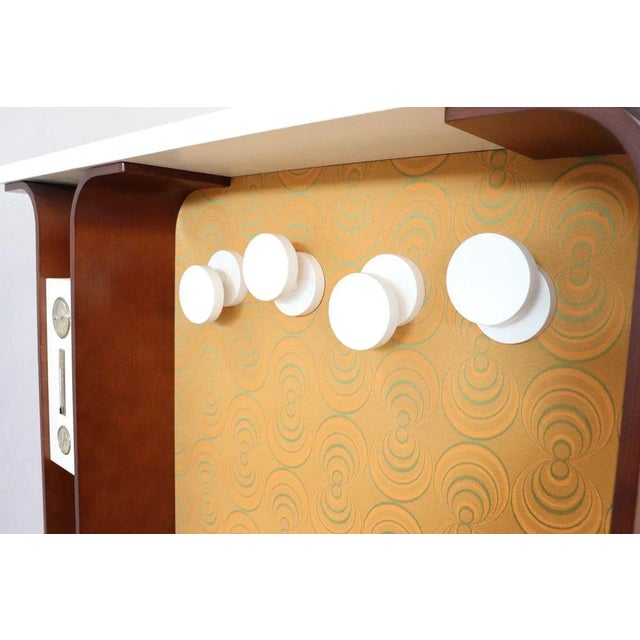 Fantastic Italian design cabinet with clothes hangers, 1960s. This type of furniture was used in the entrance of the...