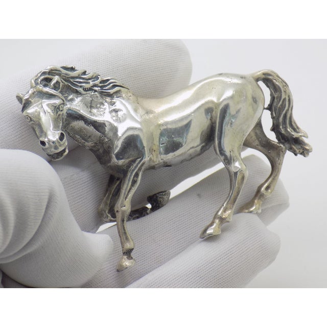 A commanding and dynamic presence for a desk, bookshelf, or collector's vitrine, this large vintage figurine captures the...