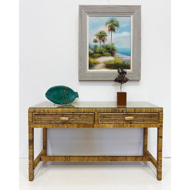 Palm Beach Regency Coastal Modern Split Rattan Console with 2 Drawers Offered for sale is a vintage Palm Beach Regency or...