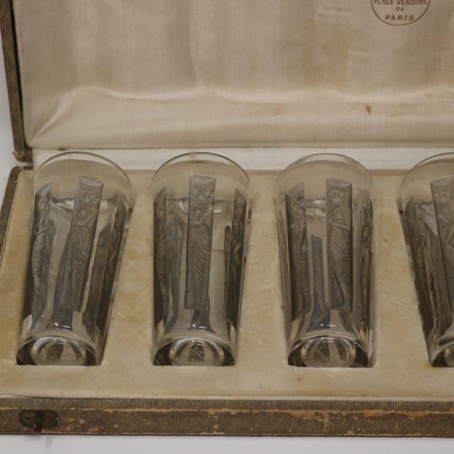 Set of six Rene Lalique Glass 'Six figurine' Shot glasses, in their original presentation box. The glasses have grey...