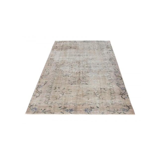 Decorative washed out handknotted vintage rug from Oushak region of Turkey. Approximately 50-60 years old. In very good...